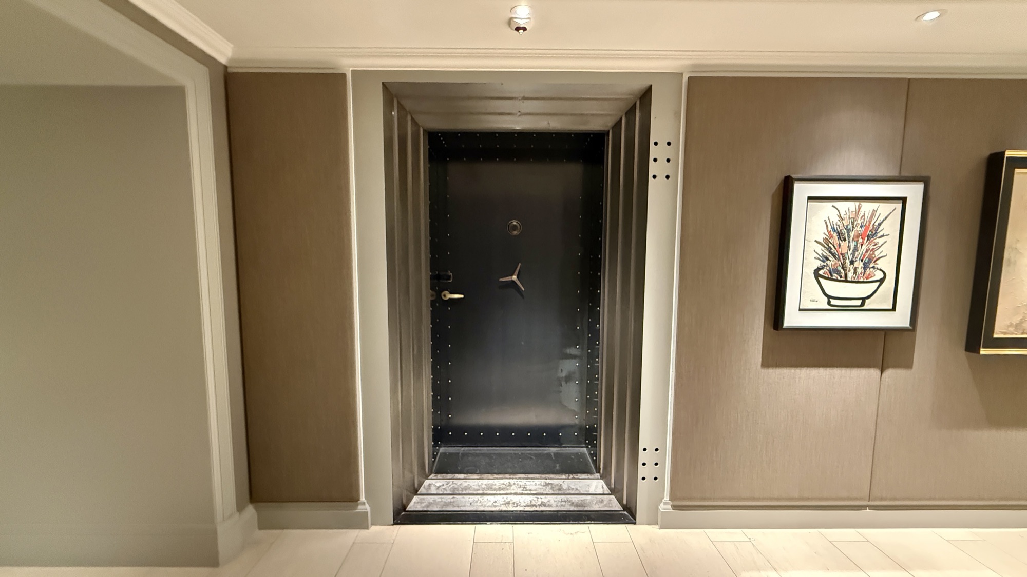 The original steel bank-vault door leading into the Vault Bar