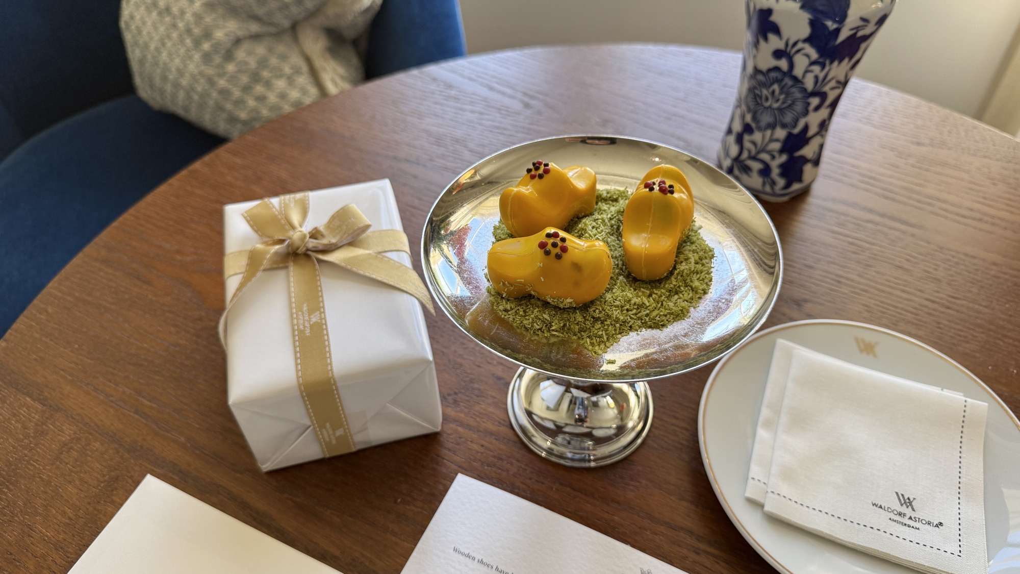 Welcome amenity of chocolates shaped like traditional Dutch wooden clogs, with a wrapped gift box