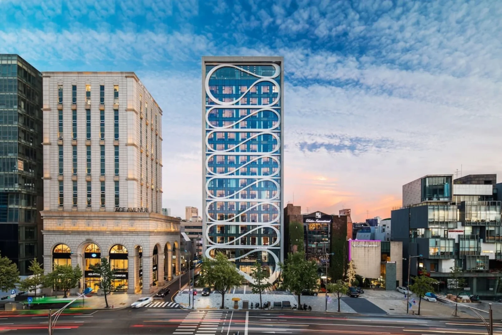 Aiden by Best Western Cheongdam in Seoul, a narrow glass tower with white looping bands across its facade, on Dosan-daero in Gangnam